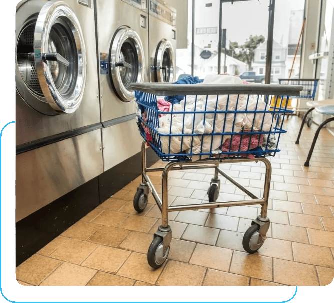 A laundry basket in front of a washing machine.